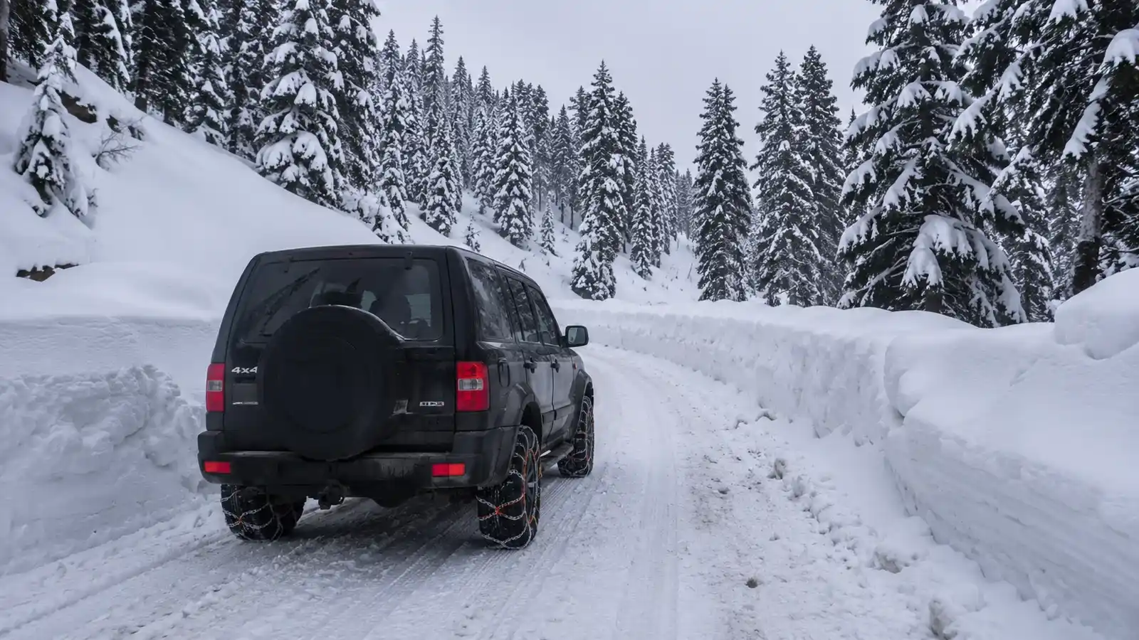 Self drive 4x4 with snow chains on the snow-covered Tangmarg to Gulmarg road in winter