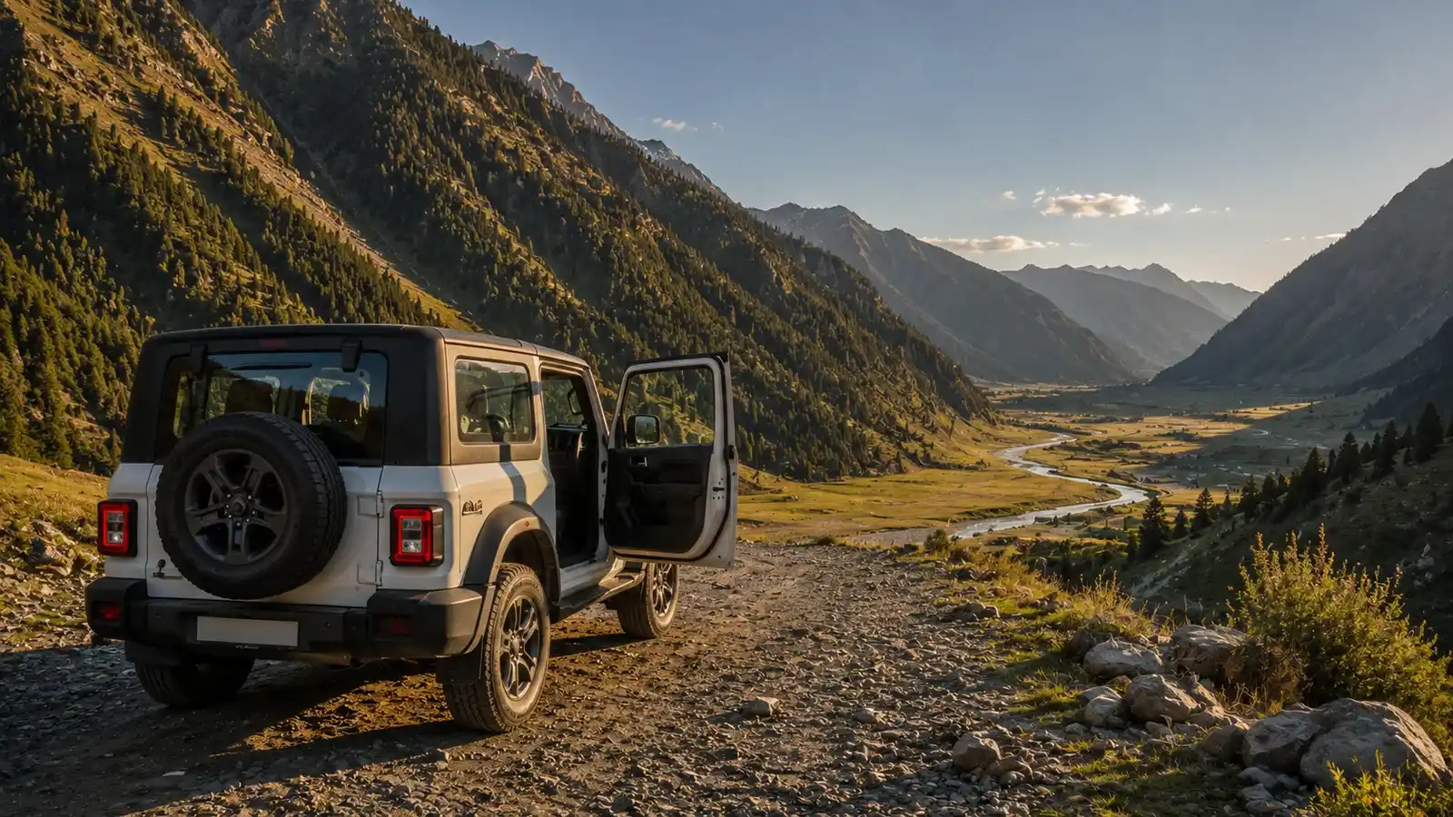 A self drive 4x4 SUV on a remote gravel track in Gurez Valley with the Kishanganga River valley and Himalayan ridges in the background, Kashmir